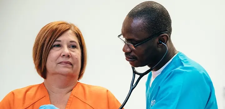 NaphCare Correctional Nurse Listening to a Patient’s Heartbeat