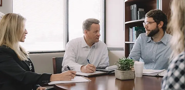 NaphCare CEO Listening During a Leadership Meeting