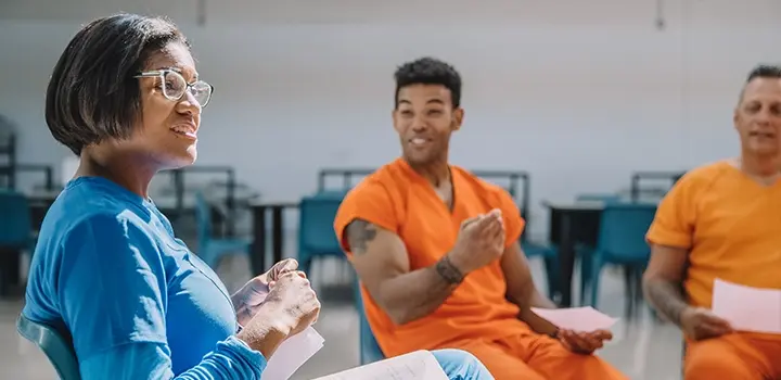NaphCare Correctional Nurse Listening to Patients During a Group Session